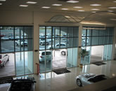 Executive Screens by Phantom at a car dealership. Solar screens keep out overpowering sunlight.